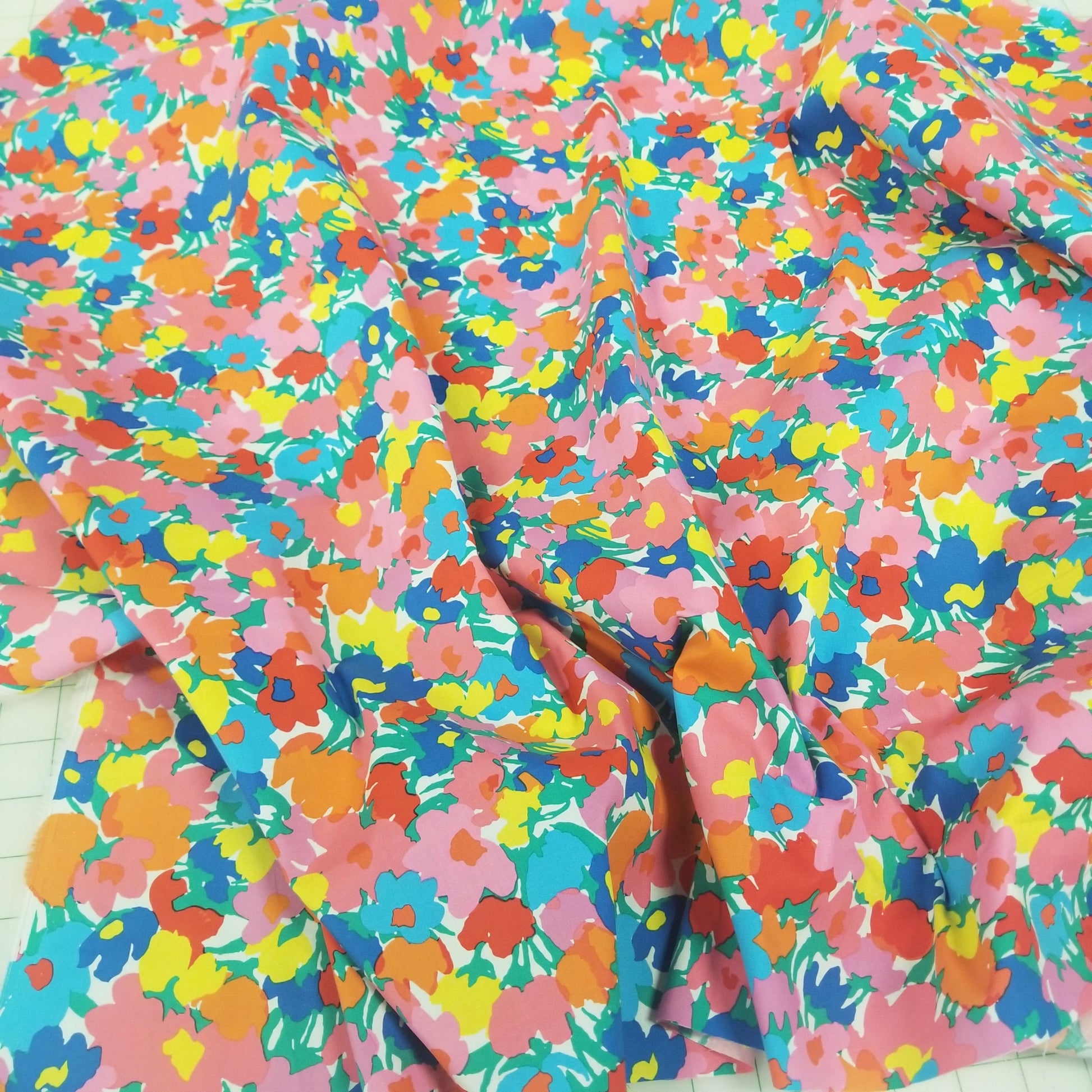 Colorful floral-patterned fabric with a tie, on a white background