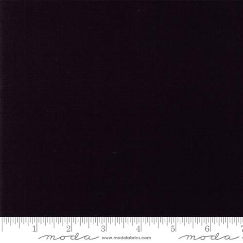 Solid black fabric swatch with a ruler at the bottom. cotton linen black for bagmaking