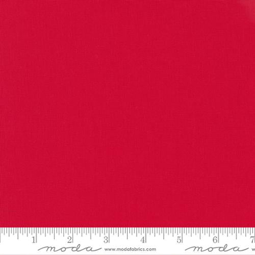 Solid red fabric swatch with a ruler at the bottom for scale.