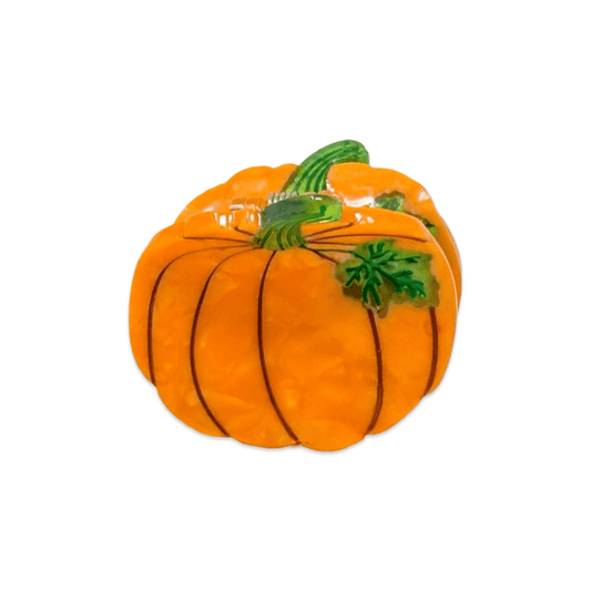 An orange pumpkin-shaped object with glossy vertical ridges, a green stem, and a small green leaf detail, isolated on a white background. Jenny Lemons Hair clip food looks