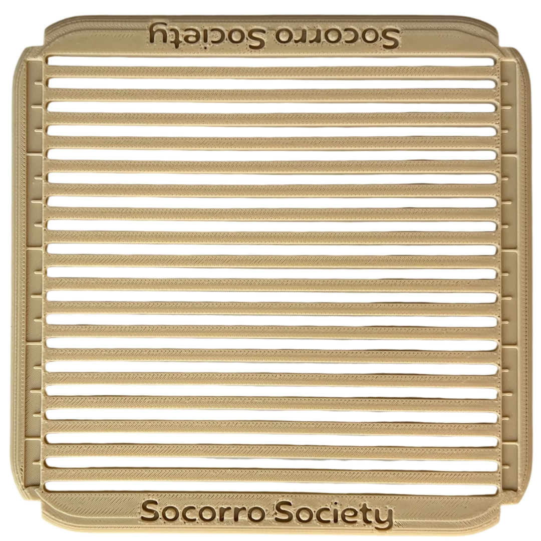 Beige metal grill with 'Socorro Society' branding on a white background