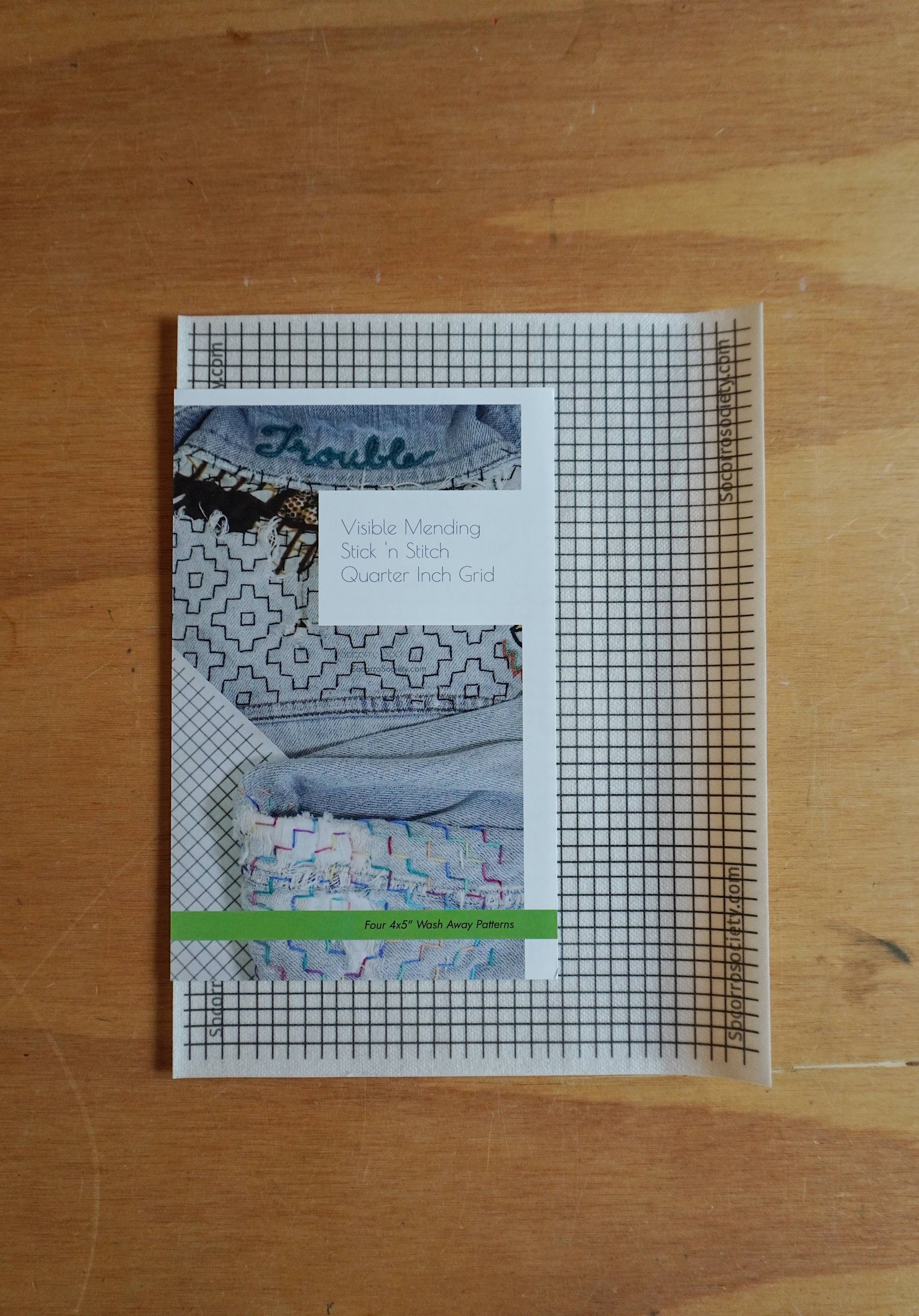 Booklet with quilt images on a wooden surface