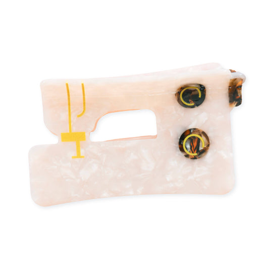 Toy resembling a sewing machine with a white background