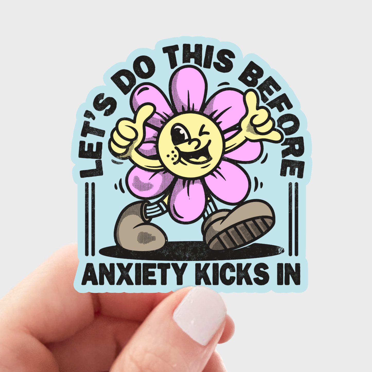 Sticker with a cartoon flower character and text held by a hand on a light gray background. Let's Do this before anxiety kicks in sticker vinyl for snarky  fun