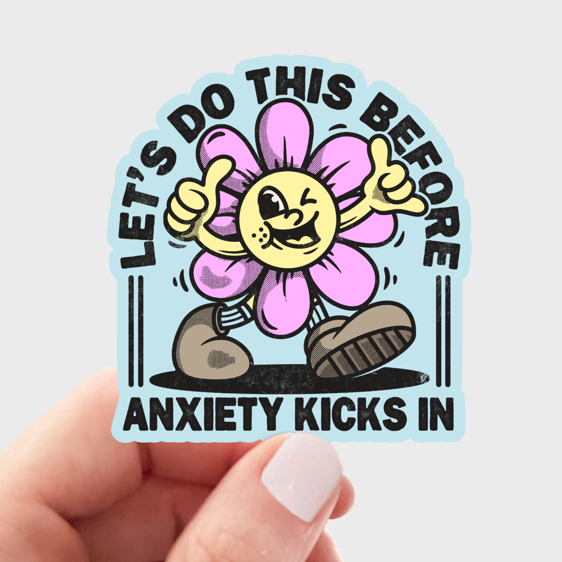 Sticker with a cartoon flower character and text held by a hand on a light gray background. Let's Do this before anxiety kicks in sticker vinyl for snarky  fun
