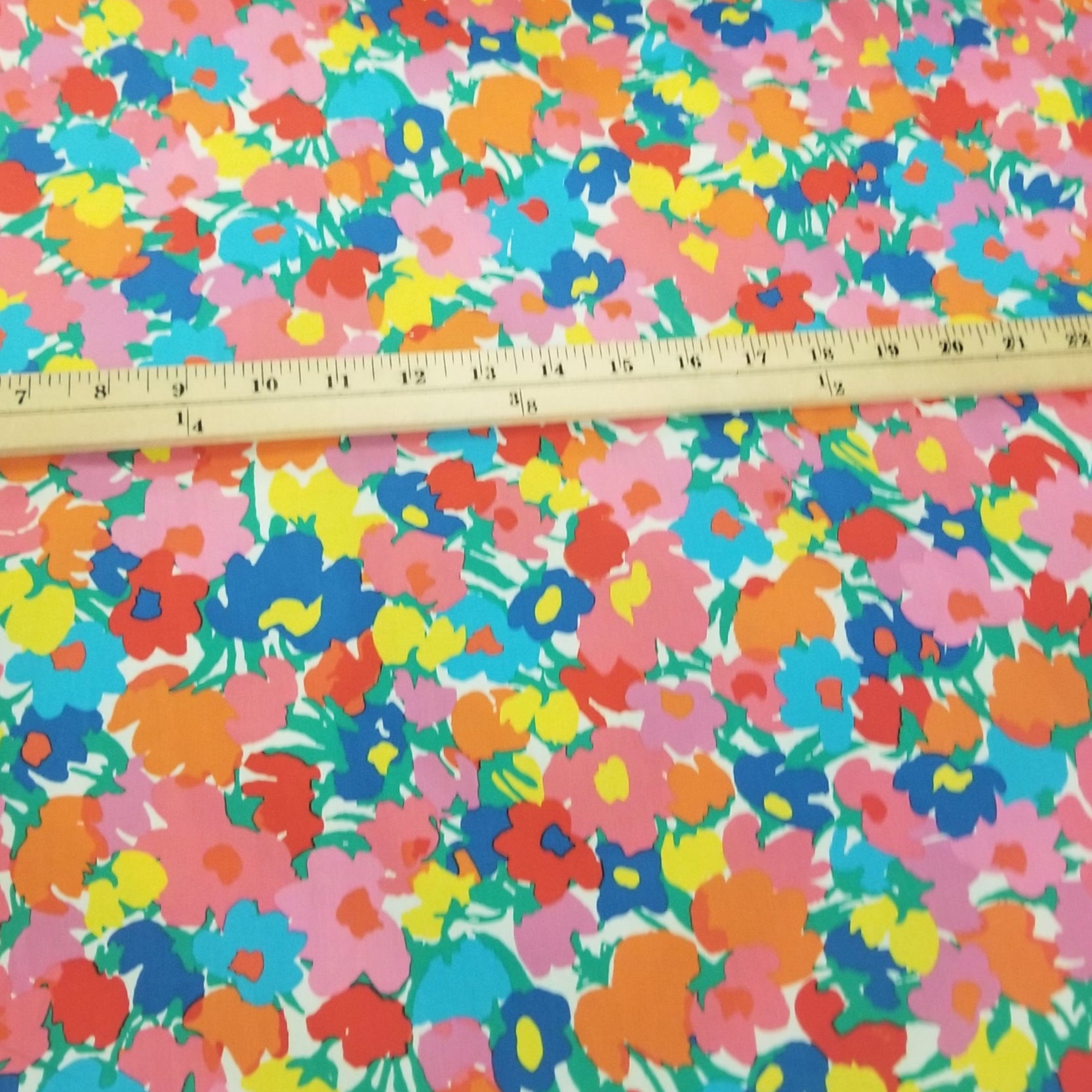 Colorful floral fabric with a ruler for scale