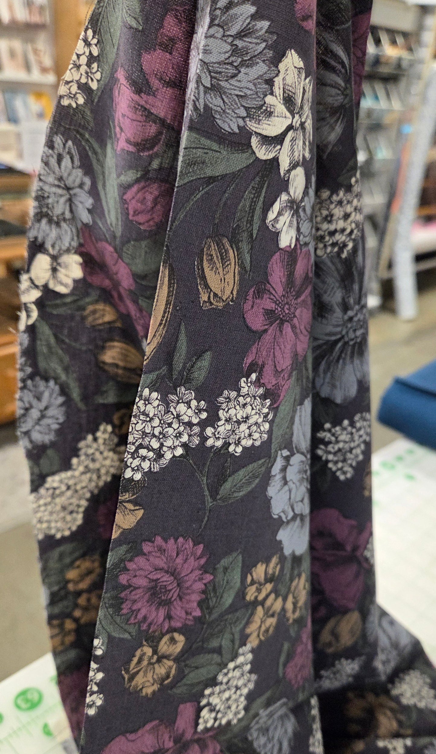 Floral-patterned fabric on a table with a blurred background