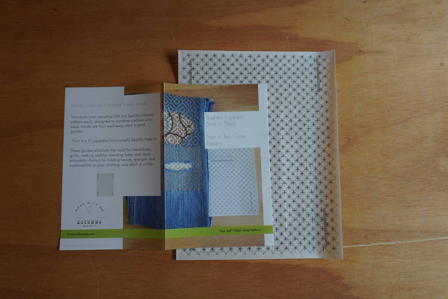 Three brochures or leaflets on a wooden surface