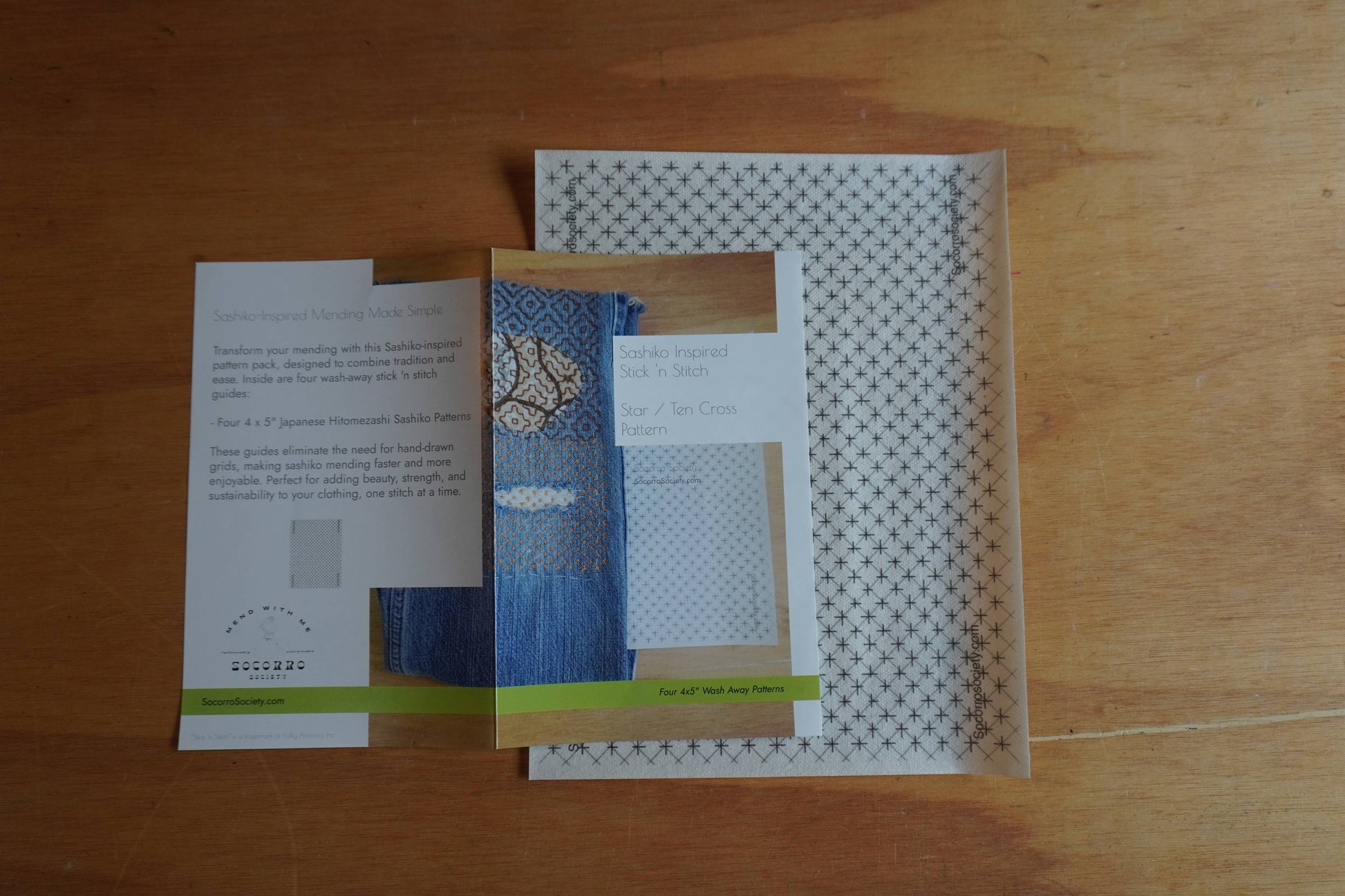Three brochures or leaflets on a wooden surface